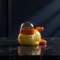 Dog playing with a yellow and orange interactive pet toy on a tiled floor.