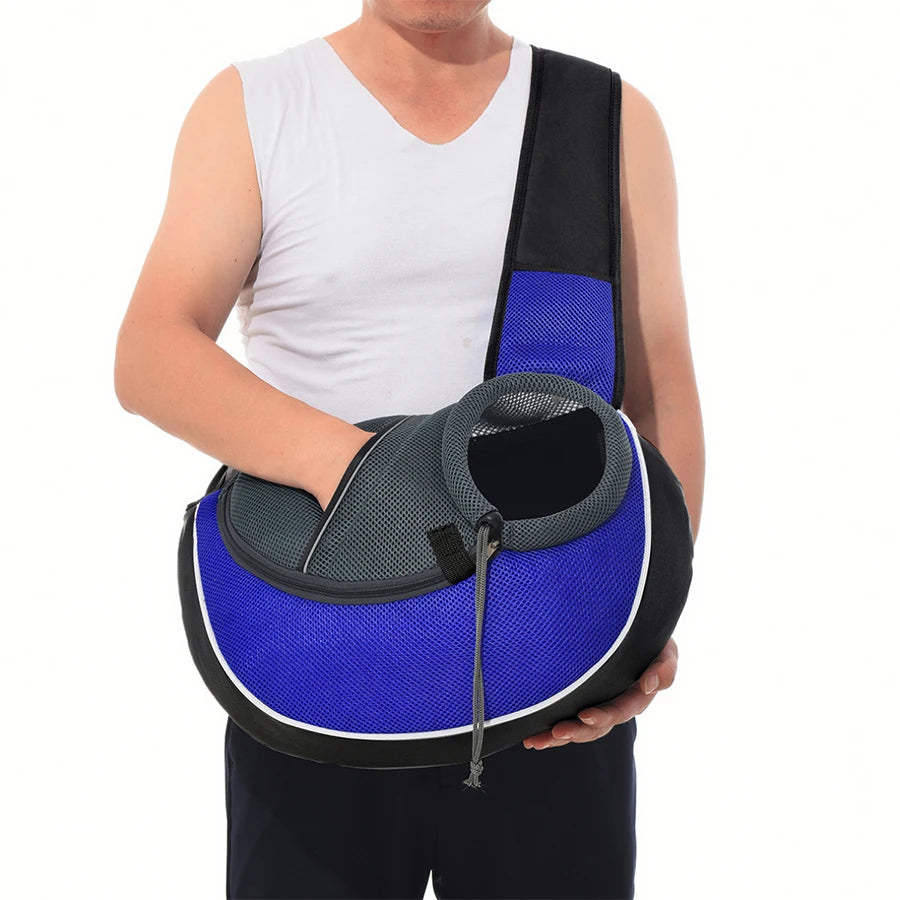 Person holding a blue and black pet carrier against a white background