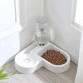 White pet bowl with food and water on a light wood floor.